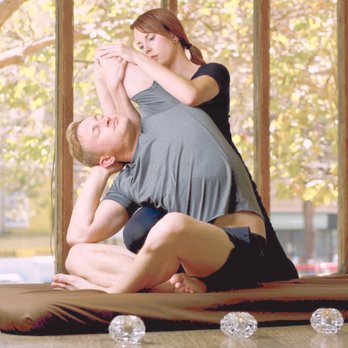 Sharon guiding a client through an assisted stretch during a Tissue Alchemy session